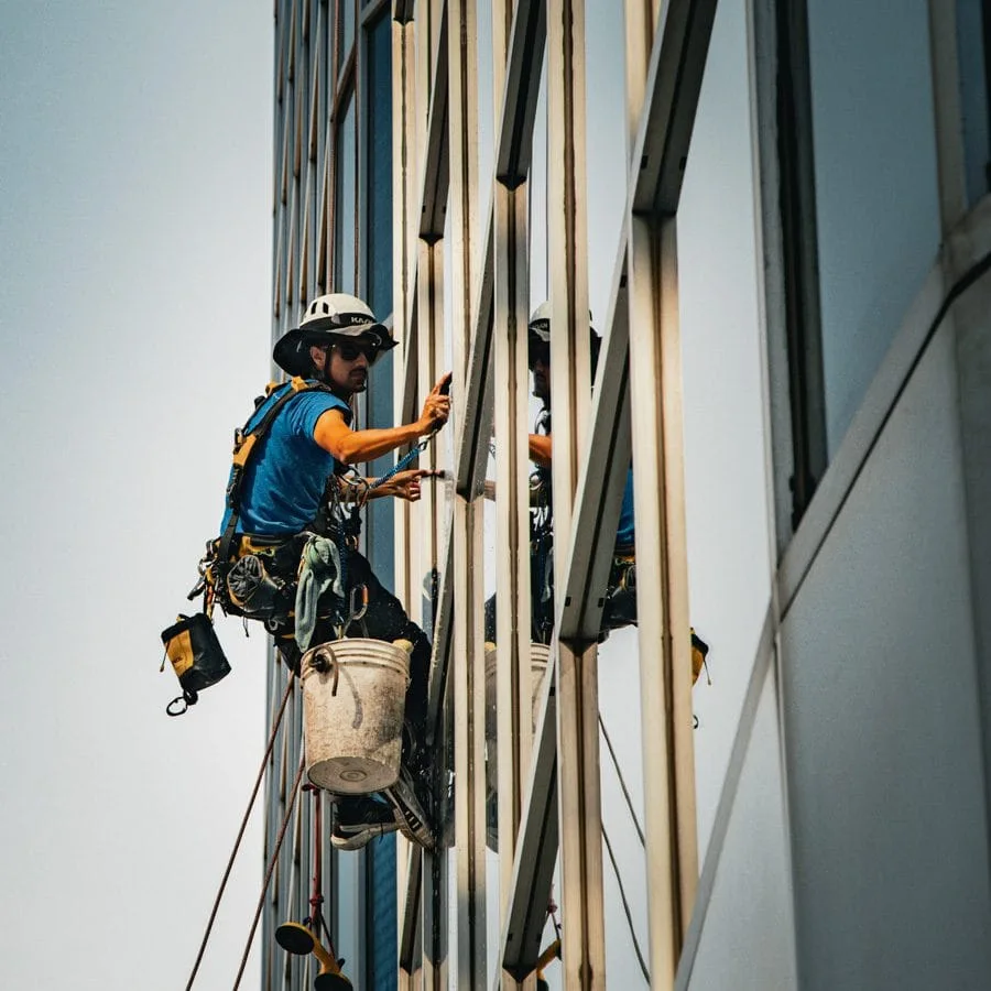 TowerCrest rope access technician cleaning exterior glass