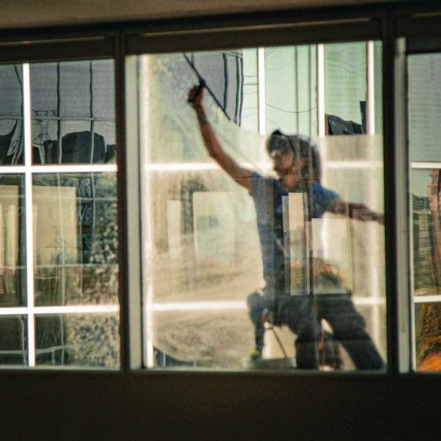 TowerCrest technician cleaning ground-level windows