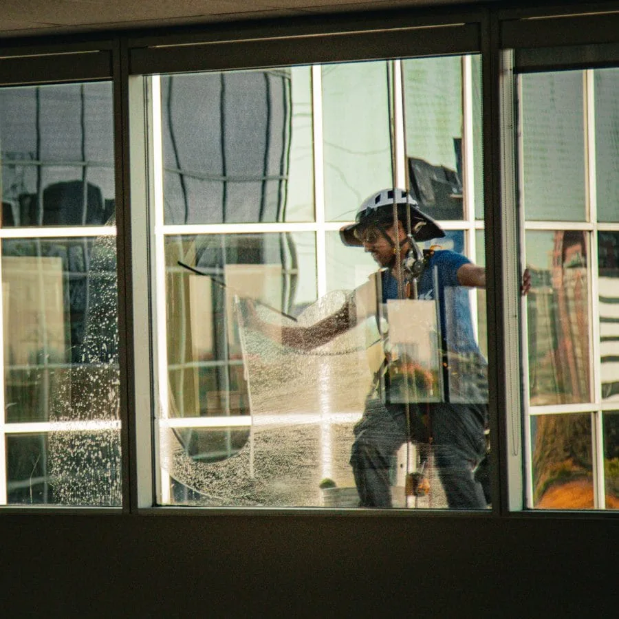 TowerCrest technician cleaning ground-level windows